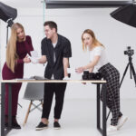 women-man-looking-through-photos-studio